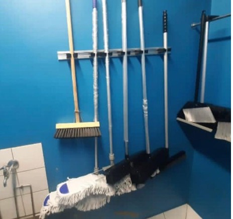 Cleaning tools stored on wall